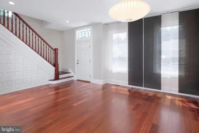 a view of a room with wooden floors and natural light