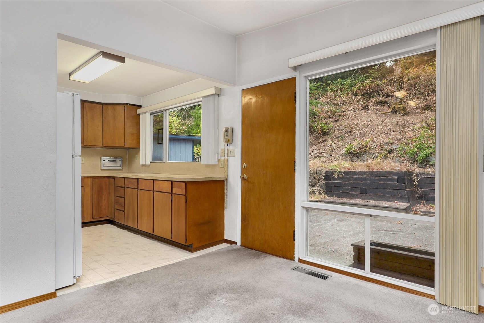 14624 Southeast Allen Rd. Bellevue, WA 98006 - Photo 8 of 26 a view of a kitchen with a fridge and wooden floor