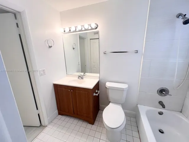 a bathroom with a sink and mirror with toilet