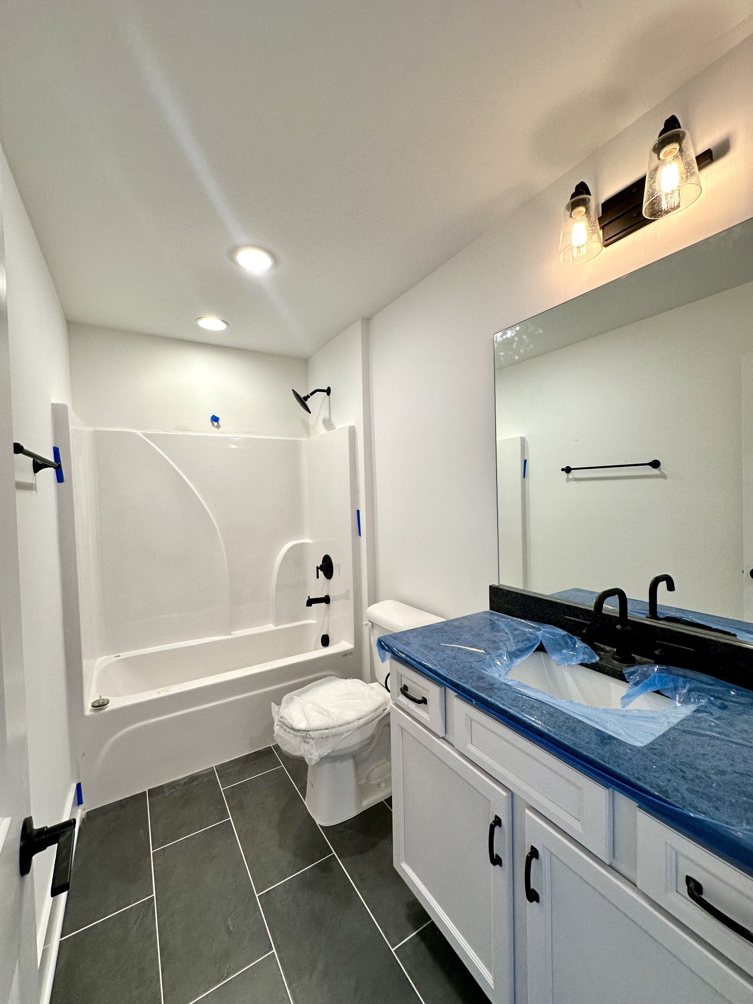 612 Whitetail Court Smyrna, TN 37167 - Photo 14 of 18 a bathroom with a granite countertop sink toilet a mirror and bathtub