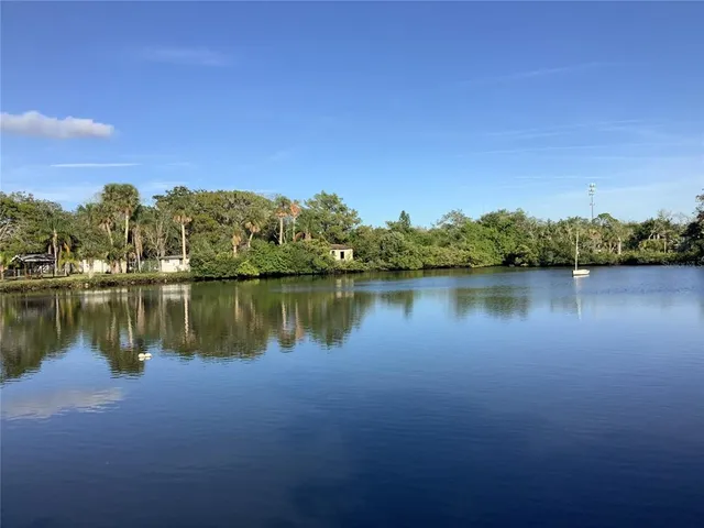 a view of a lake with houses in the background