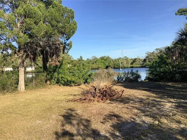 a view of a lake with a house in the background