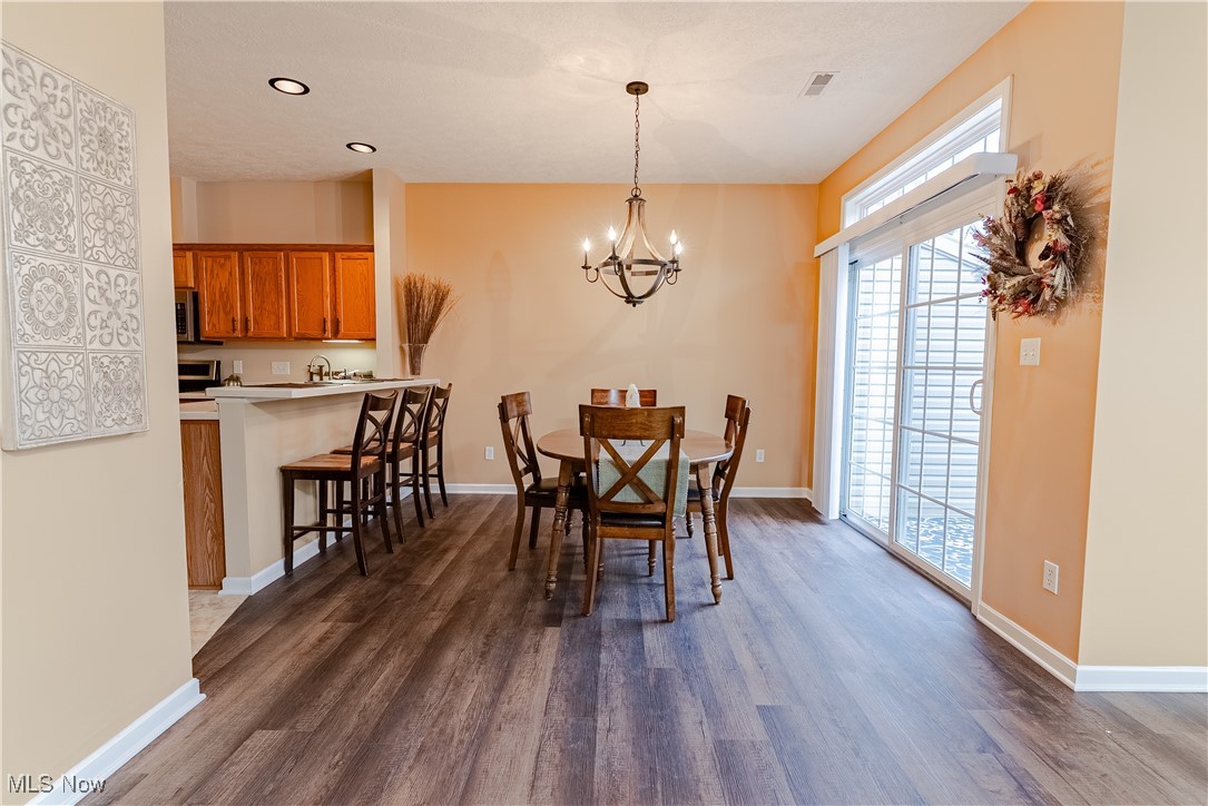 5645 Clingan Road, Unit 23B Struthers, OH 44471 - Photo 10 of 38 Dining area featuring a chandelier, dark wood finished floors, and recessed lighting
