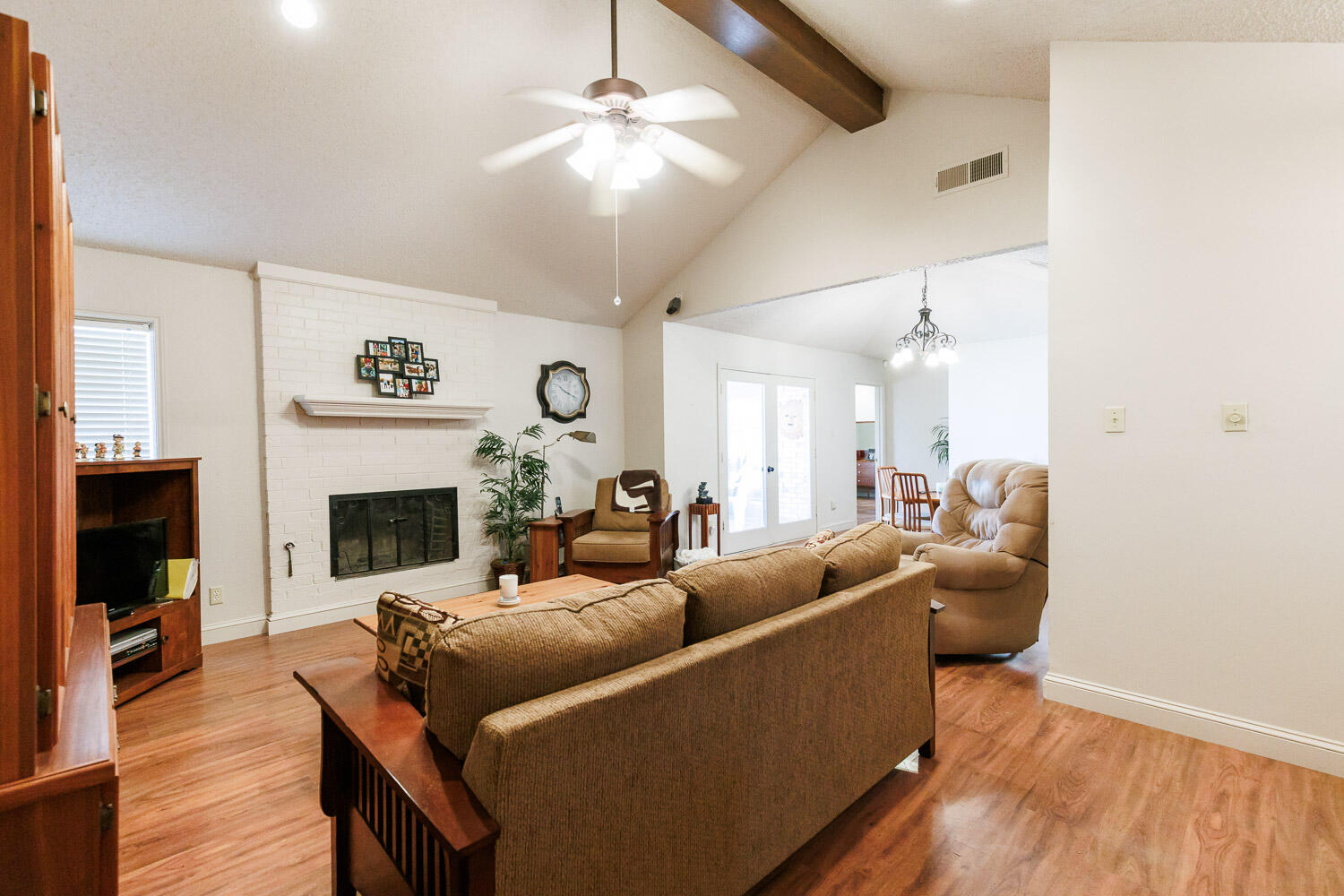 5728 92nd Street Lubbock, TX 79424 - Photo 11 of 40 a living room with furniture a fireplace and a flat screen tv