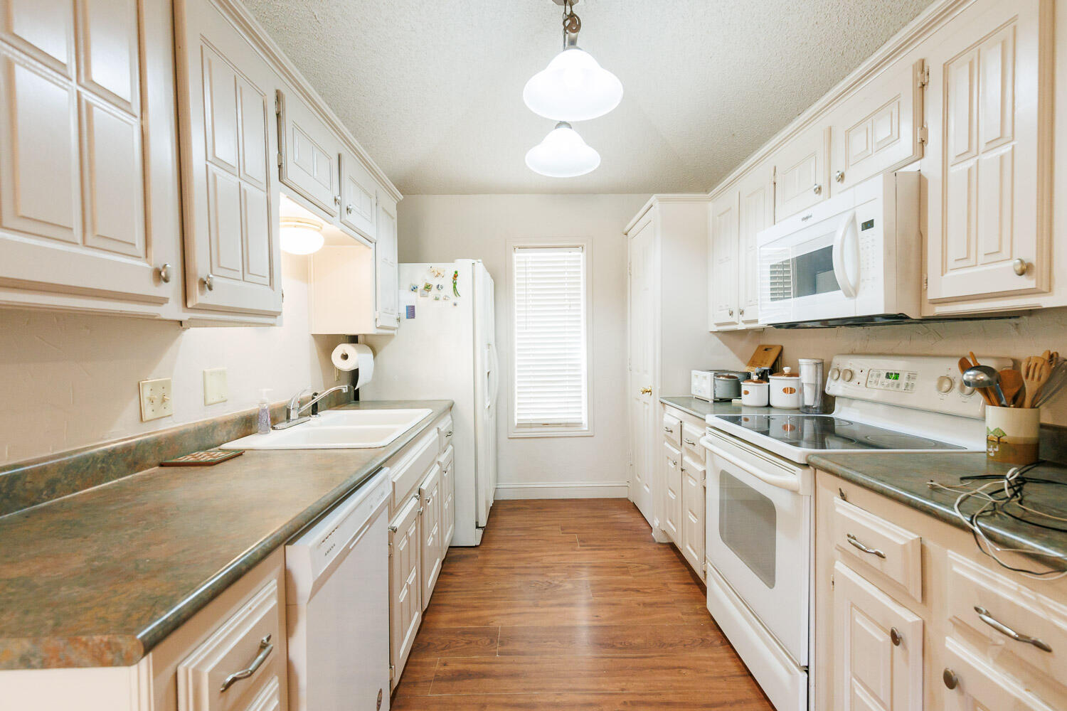 5728 92nd Street Lubbock, TX 79424 - Photo 15 of 40 a kitchen with stainless steel appliances granite countertop a sink and cabinets
