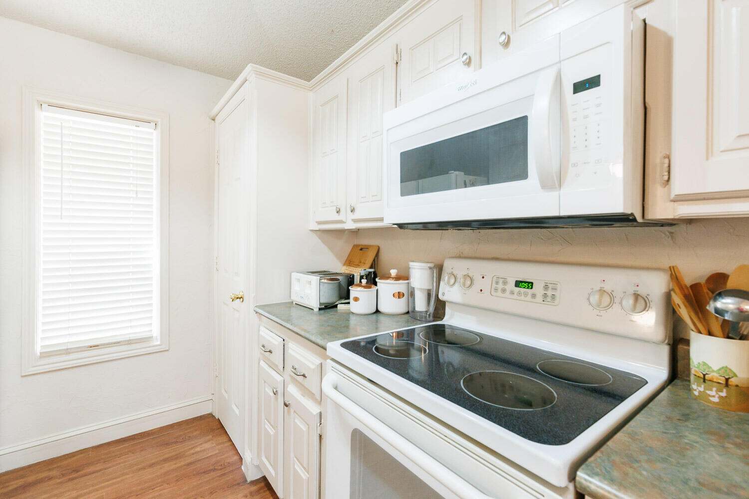 5728 92nd Street Lubbock, TX 79424 - Photo 16 of 40 a kitchen with stainless steel appliances granite countertop a sink and a microwave
