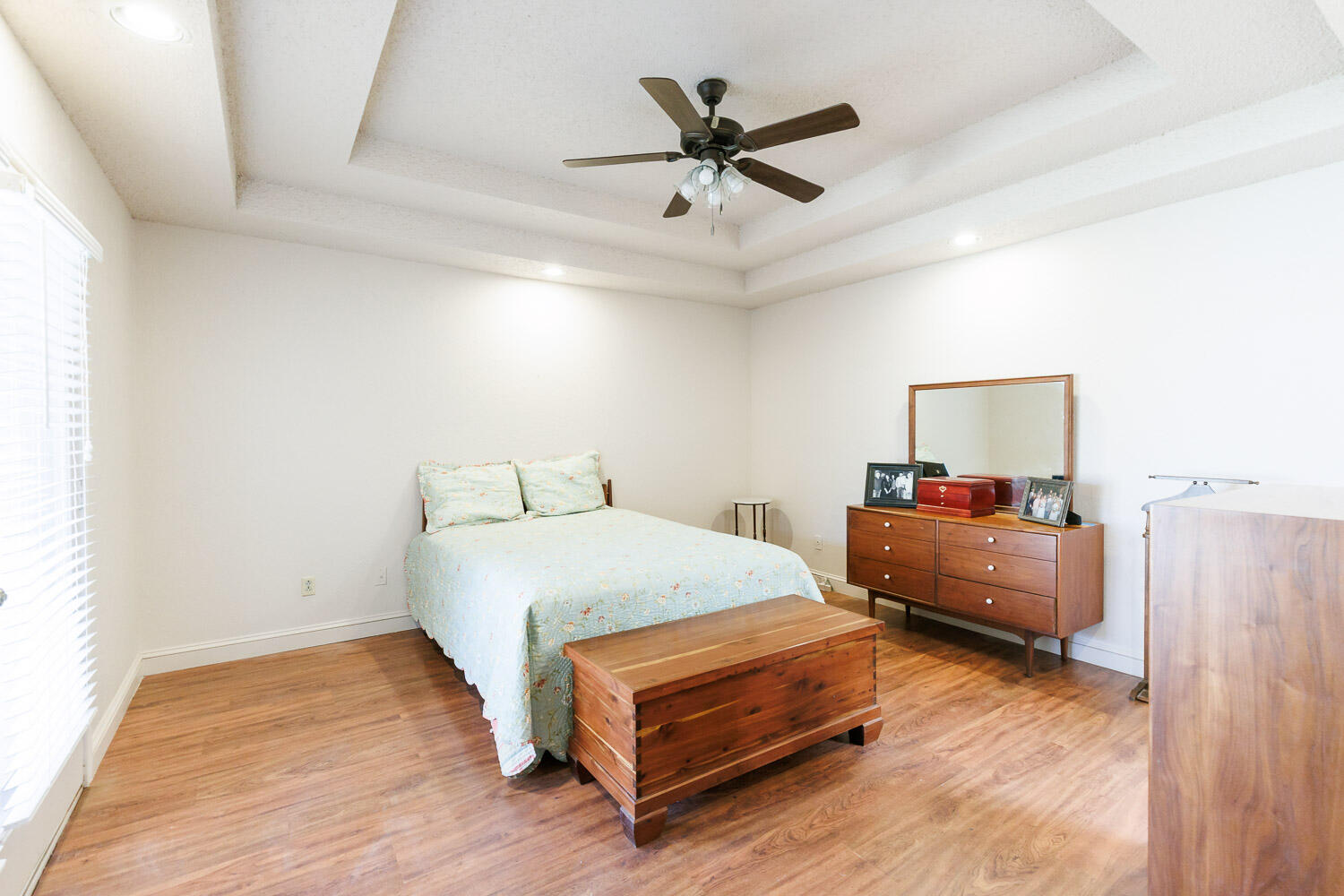 5728 92nd Street Lubbock, TX 79424 - Photo 19 of 40 a bedroom with a bed and a ceiling fan