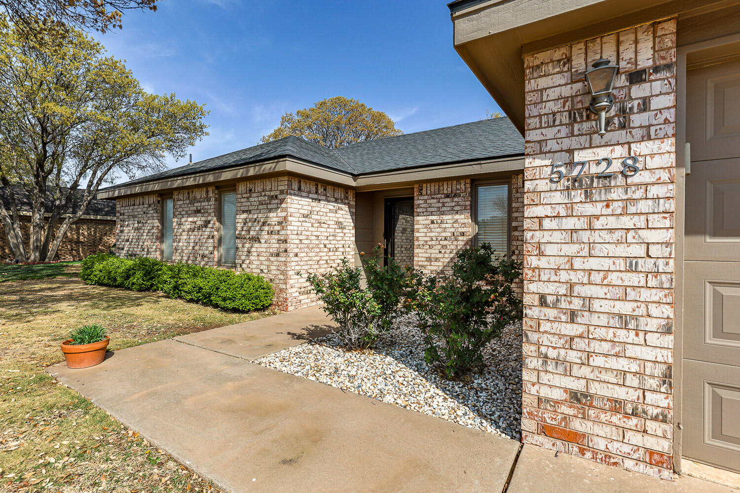 5728 92nd Street Lubbock, TX 79424 - Photo 2 of 40 a front view of a house with a yard