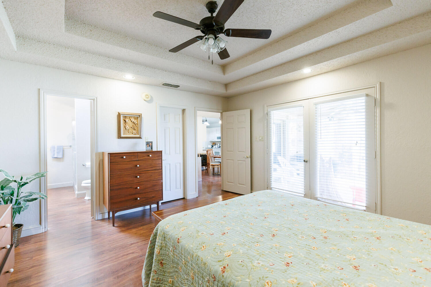 5728 92nd Street Lubbock, TX 79424 - Photo 21 of 40 a bedroom with a bed and a chandelier