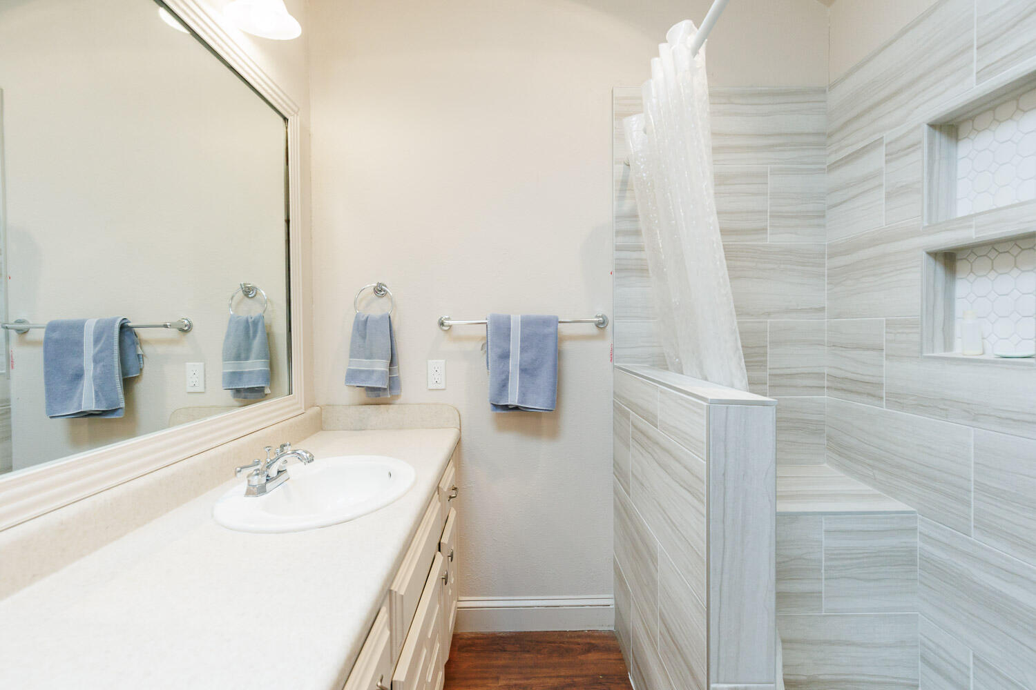 5728 92nd Street Lubbock, TX 79424 - Photo 23 of 40 a bathroom with a sink and a mirror