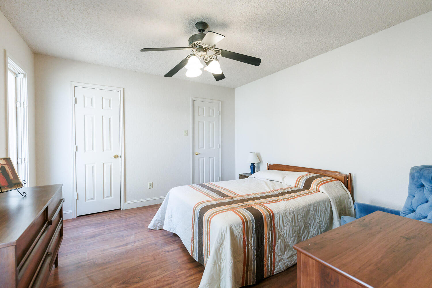 5728 92nd Street Lubbock, TX 79424 - Photo 26 of 40 a bedroom with two beds and a chandelier