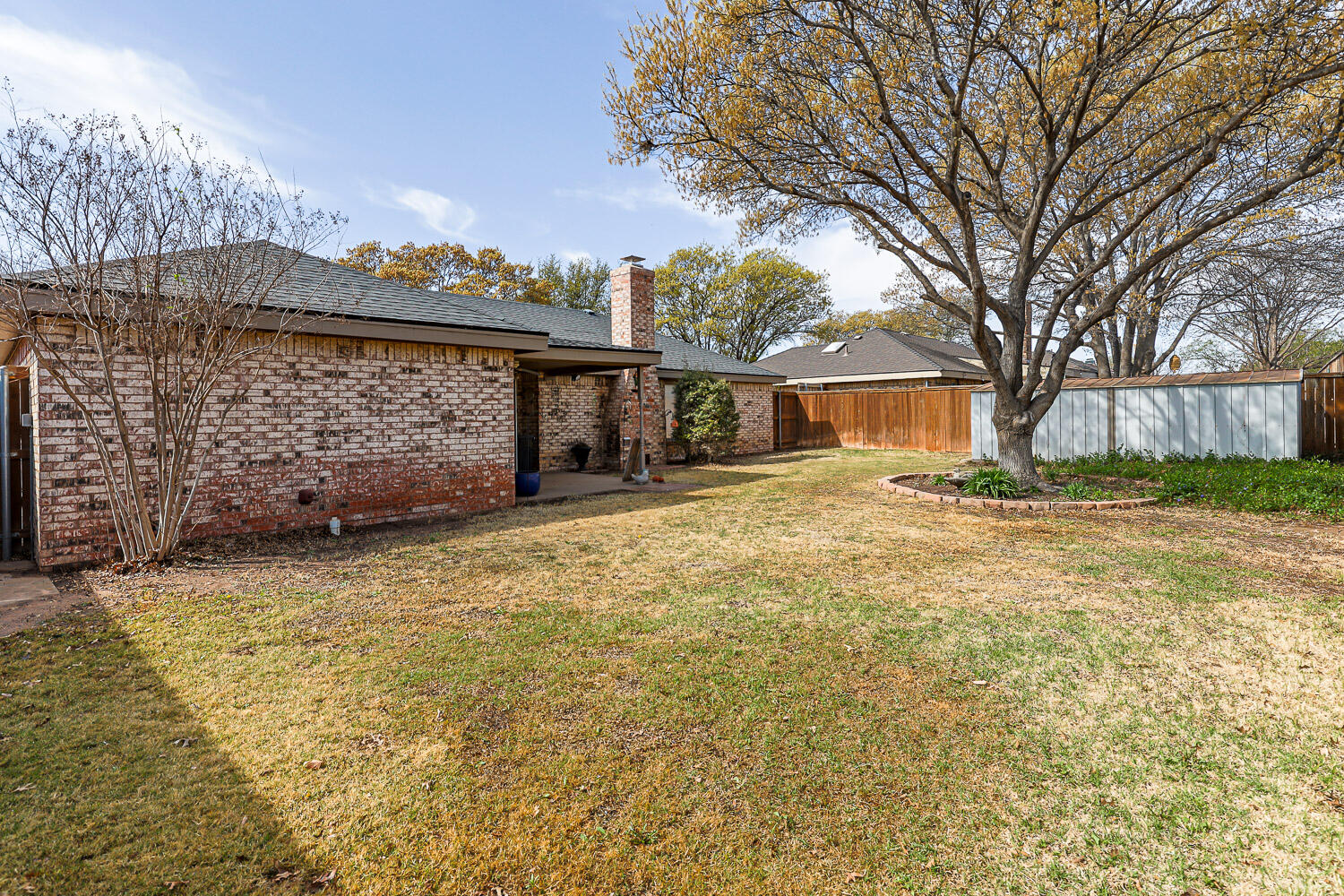 5728 92nd Street Lubbock, TX 79424 - Photo 38 of 40 a view of a house with a yard covered with snow and trees