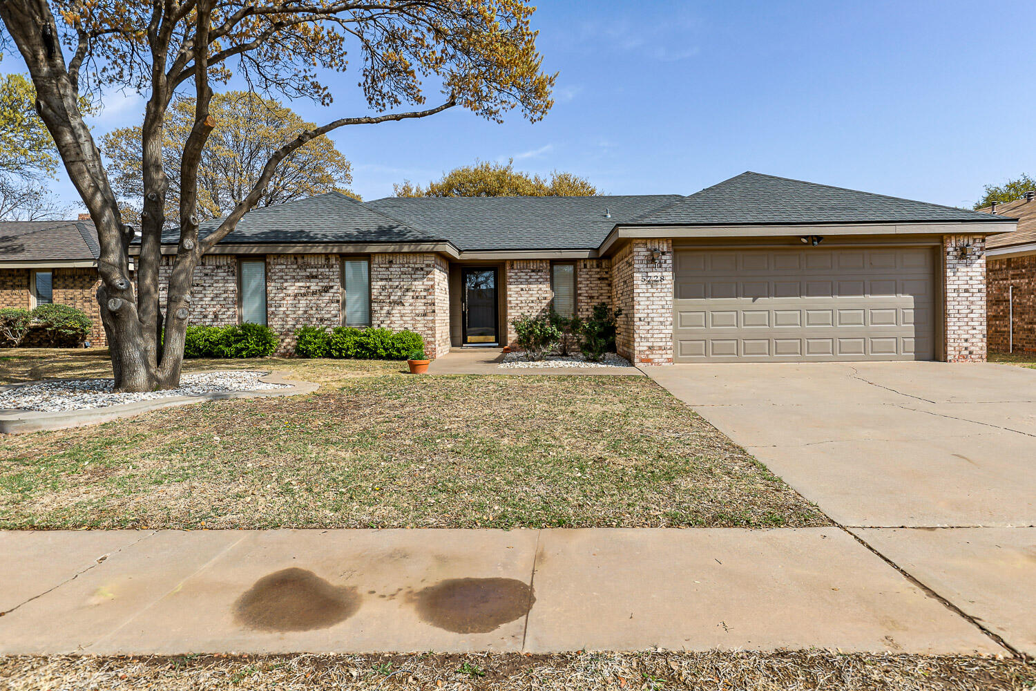 5728 92nd Street Lubbock, TX 79424 - Photo 6 of 40 a front view of a house with a yard and garage