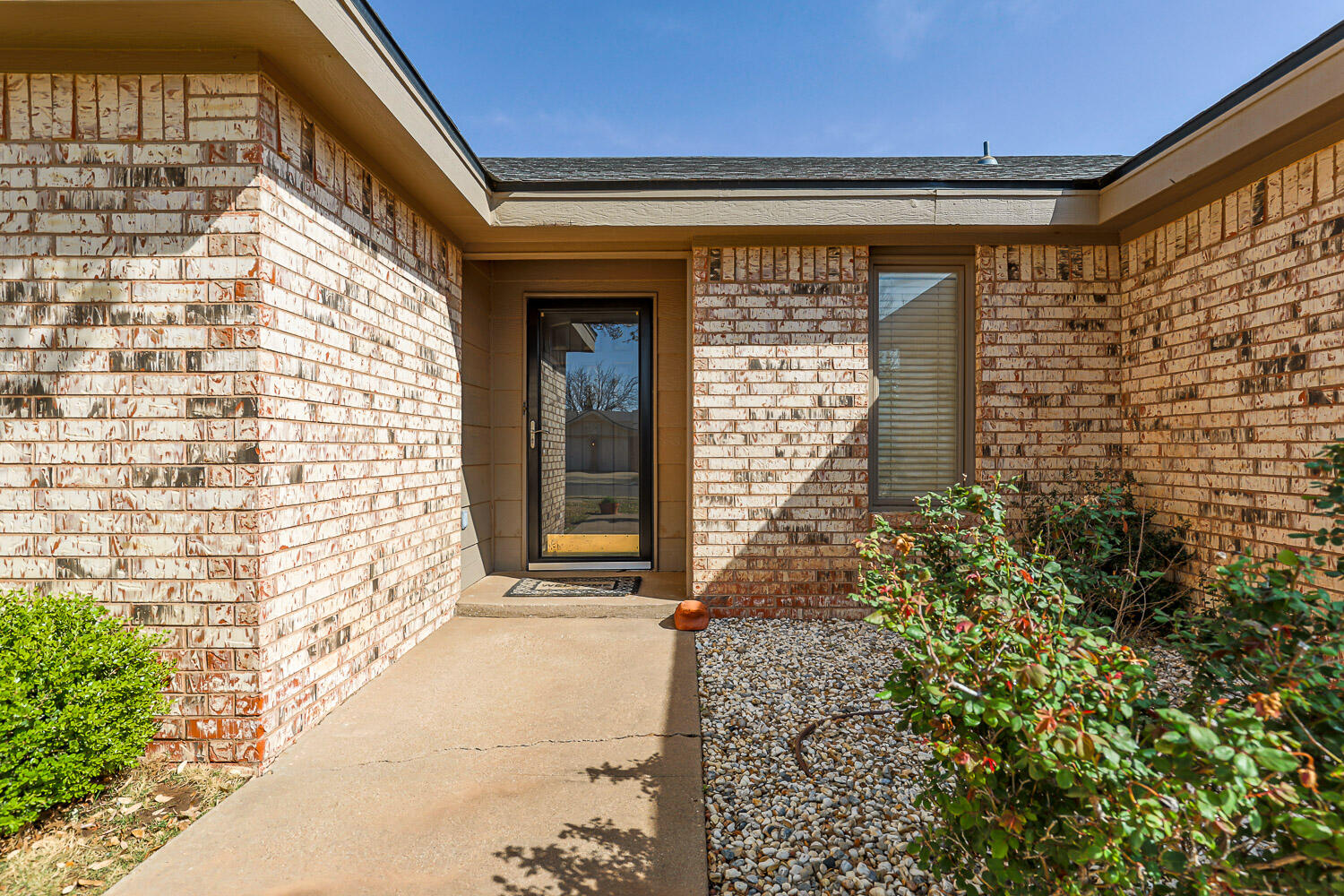 5728 92nd Street Lubbock, TX 79424 - Photo 7 of 40 a front view of a house with a blue gate