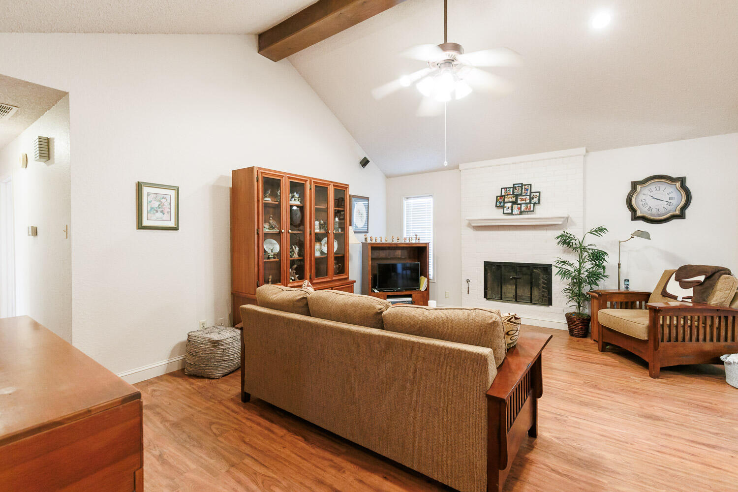 5728 92nd Street Lubbock, TX 79424 - Photo 9 of 40 a living room with furniture a fireplace and a flat screen tv