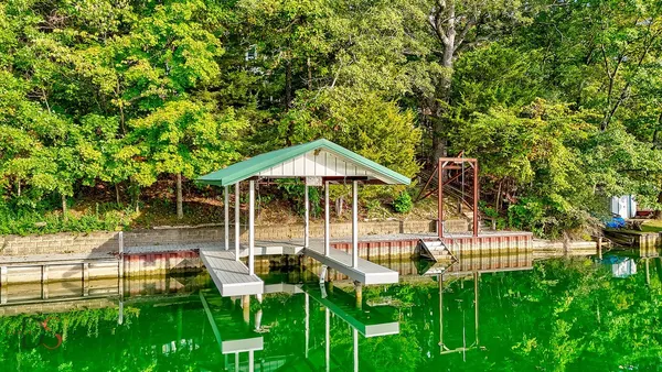 a view of backyard with swimming pool and patio