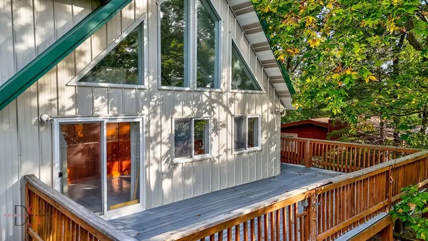 a view of a small house with roof deck