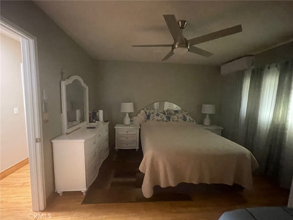 26326 Investors Hemet, CA 92544 - Photo 15 of 46 a bedroom with a bed and a refrigerator