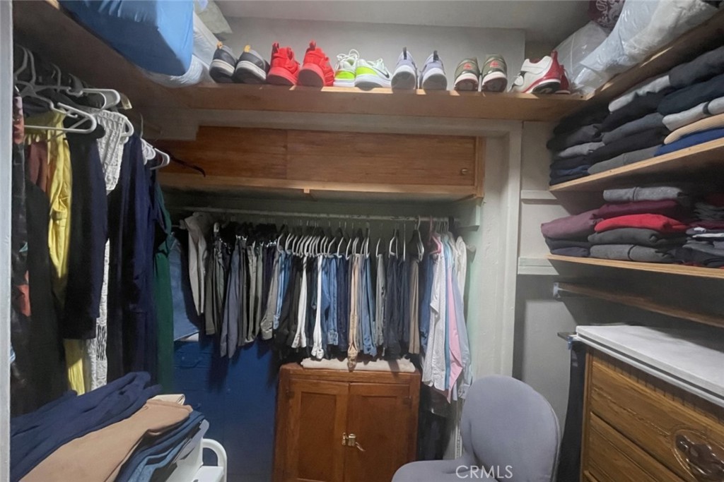 26326 Investors Hemet, CA 92544 - Photo 17 of 46 a view of walk in closet with clothes and shoes