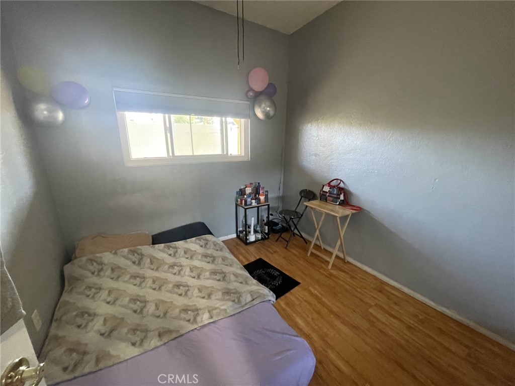 26326 Investors Hemet, CA 92544 - Photo 19 of 46 a bedroom with a bed and wooden floor