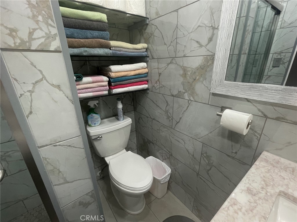 26326 Investors Hemet, CA 92544 - Photo 20 of 46 a white toilet sitting next to a shower and a sink