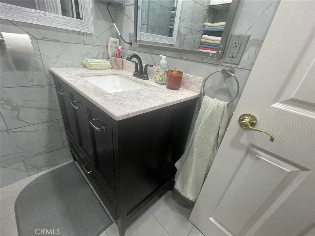 26326 Investors Hemet, CA 92544 - Photo 22 of 46 a bathroom with a sink and mirror