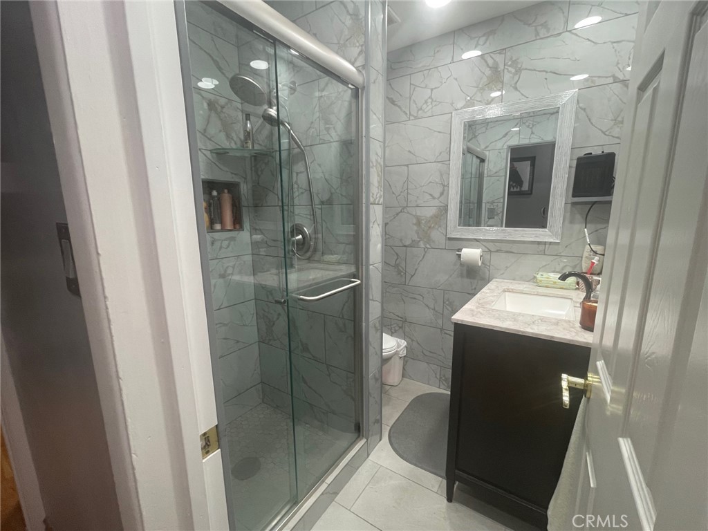 26326 Investors Hemet, CA 92544 - Photo 23 of 46 a bathroom with a shower and a sink
