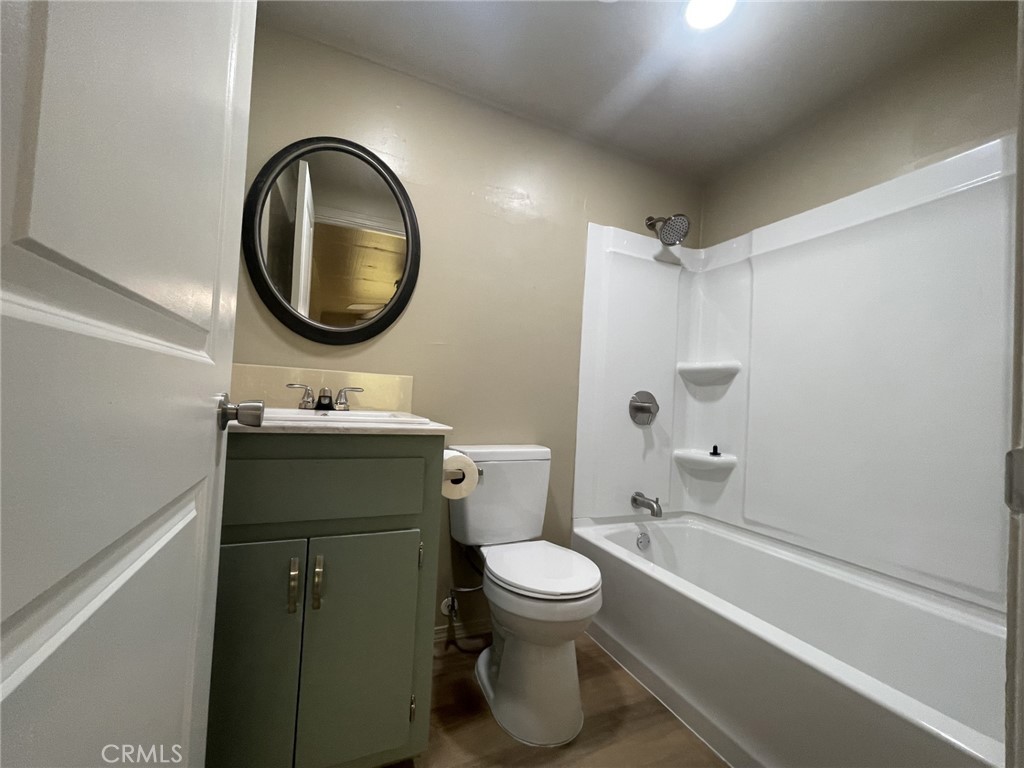 26326 Investors Hemet, CA 92544 - Photo 28 of 46 a bathroom with a toilet sink and mirror