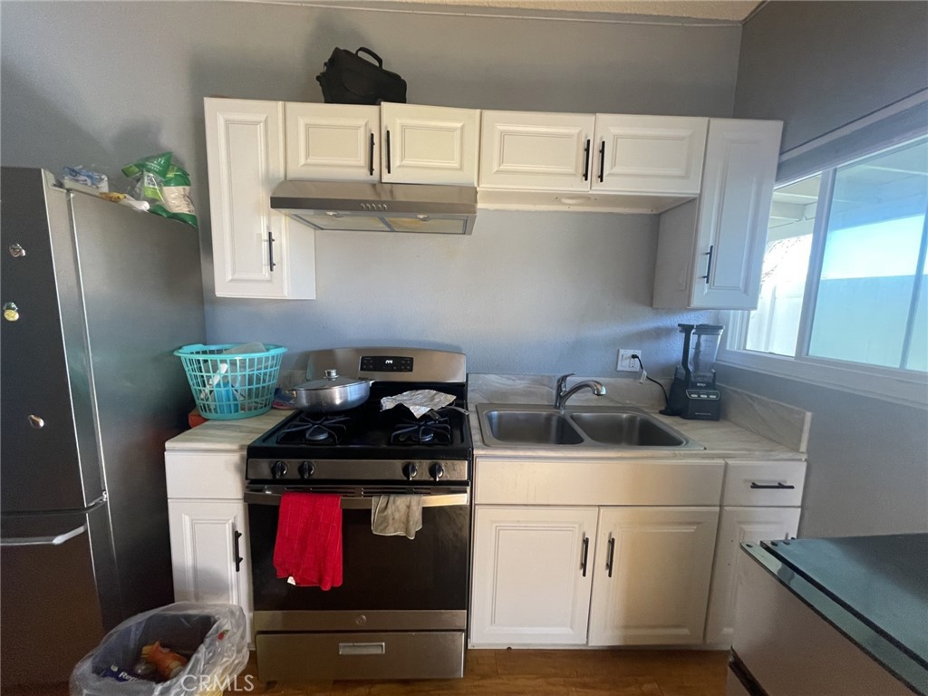 26326 Investors Hemet, CA 92544 - Photo 32 of 46 a kitchen with stainless steel appliances granite countertop a stove and a refrigerator