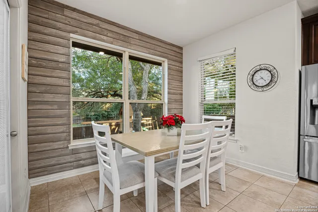 a dining room with furniture and window
