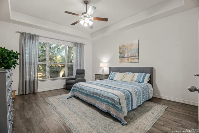 a spacious bedroom with a large bed and a large window