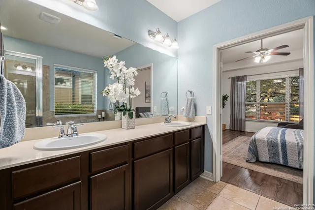 a en suite bathroom with a double vanity sink and a mirror