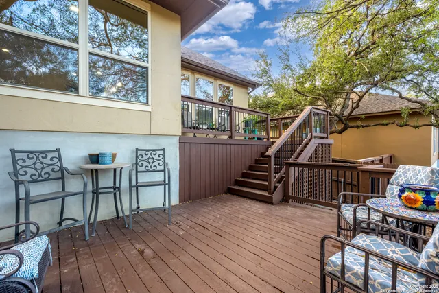 a dining room with wooden floor and furniture