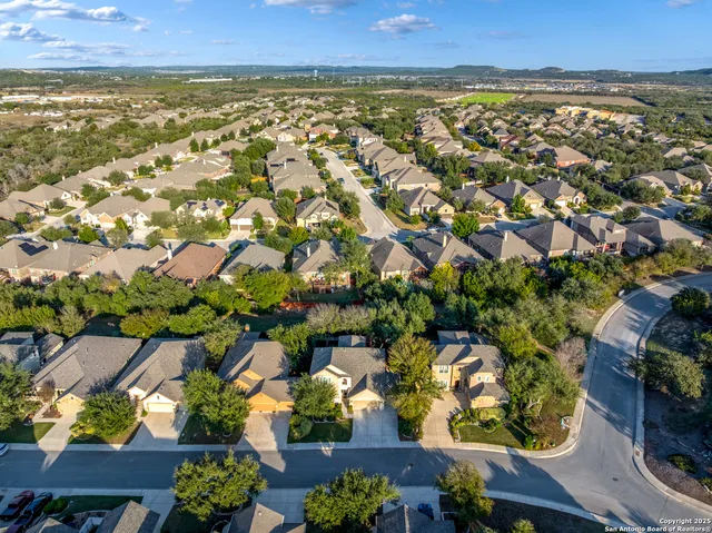 an aerial view of residential houses with outdoor space
