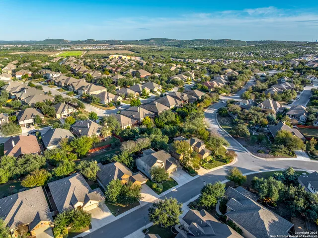an aerial view of residential building and lake