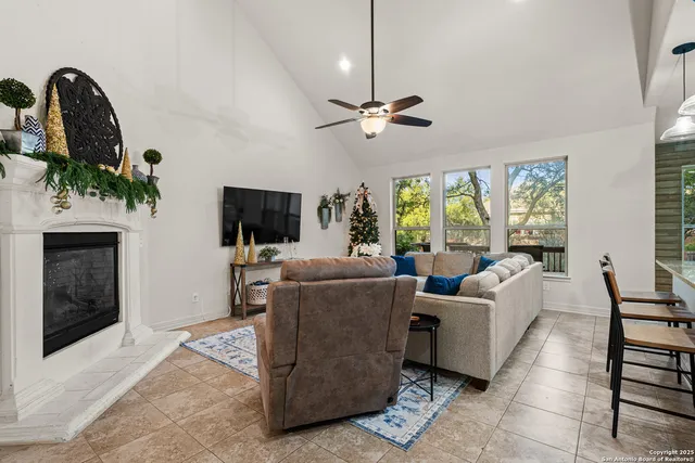 a living room with furniture a flat screen tv and a fireplace
