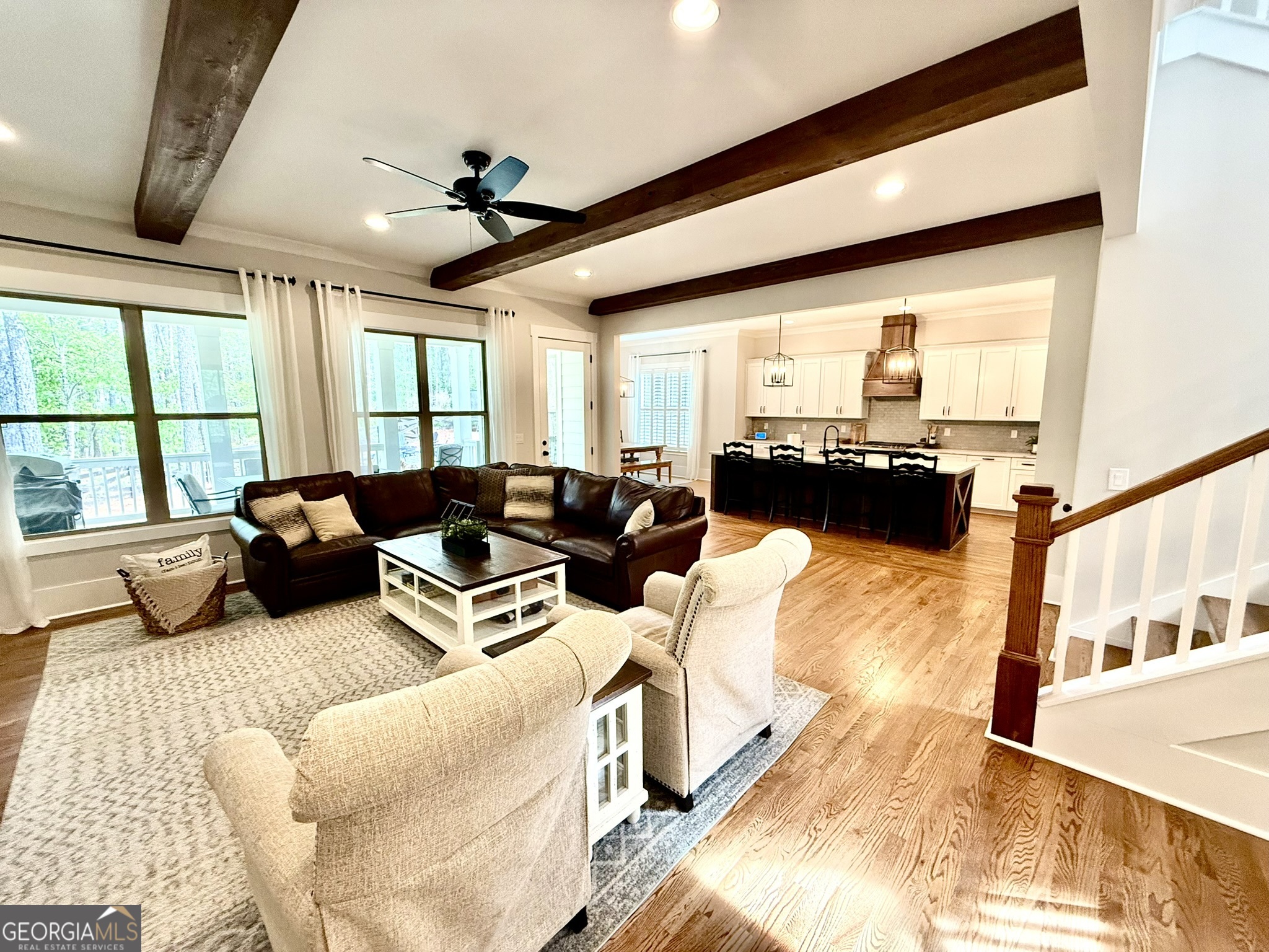 120 Spring Creek Drive Rutledge, GA 30663 - Photo 6 of 38 a living room with furniture ceiling fan and a large window