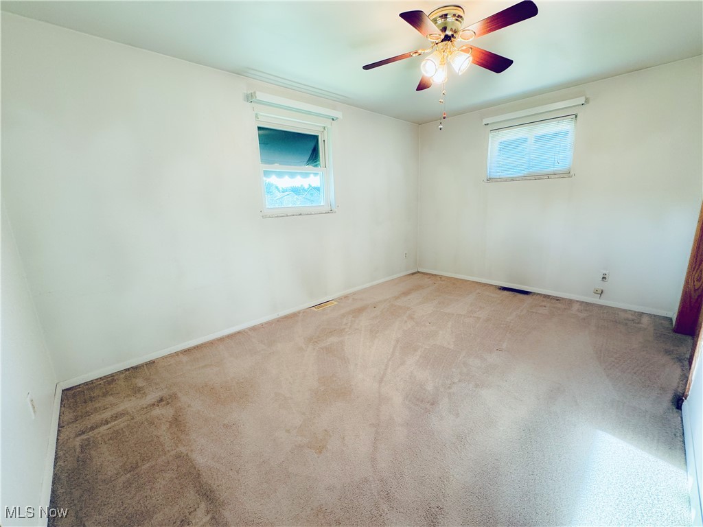 304 Stone Road Belpre, OH 45714 - Photo 7 of 34 Carpeted spare room featuring plenty of natural light and ceiling fan