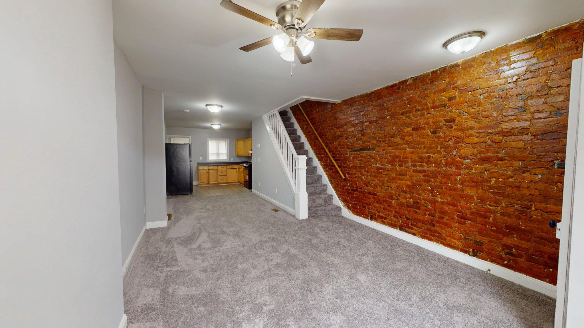 1826 Ramsay Street Baltimore, MD 21223 - Photo 2 of 16 Living Room with Exposed Brick