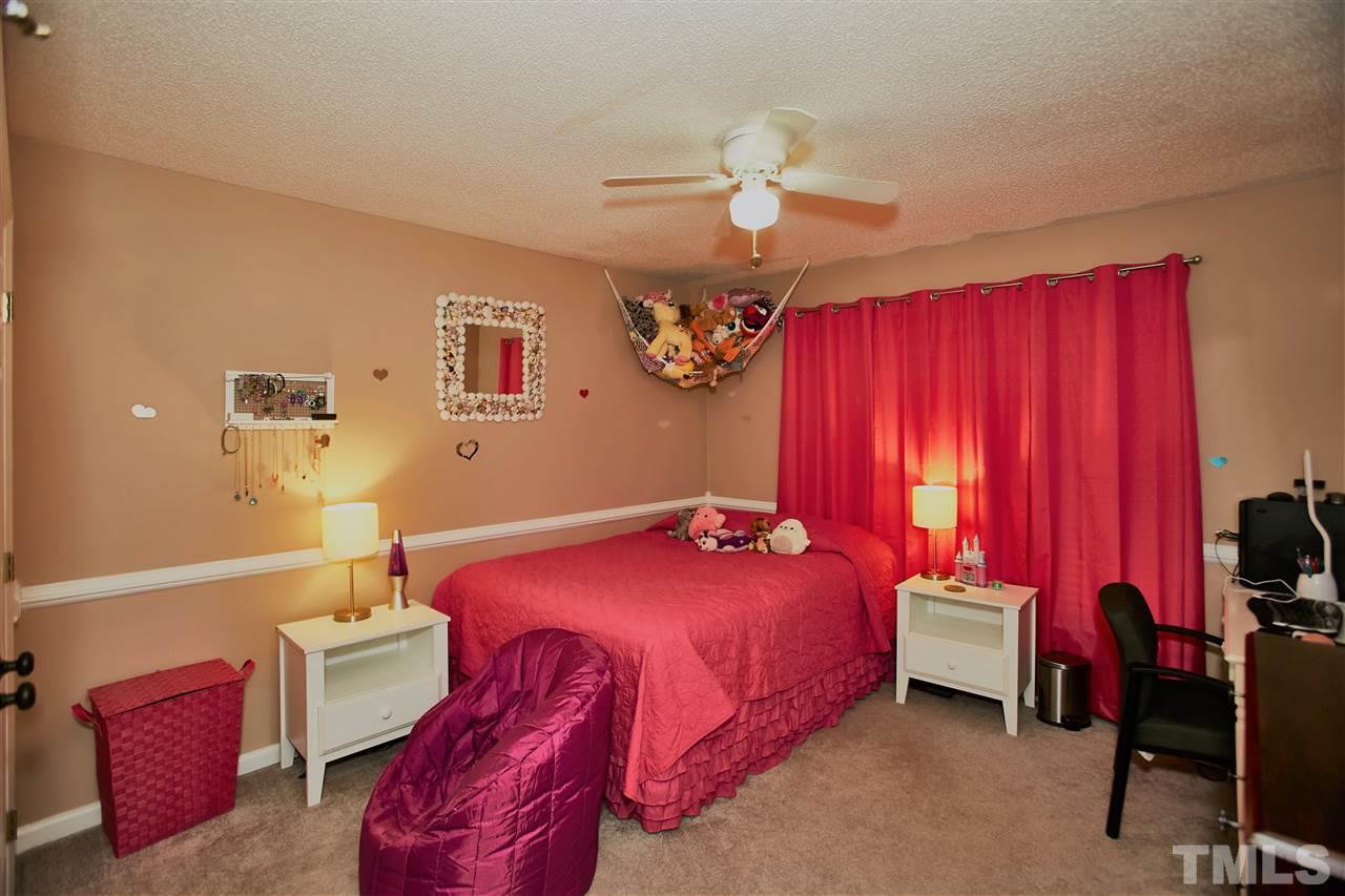 517 Jordan Ridge Lane Raleigh, NC 27603 - Photo 12 of 16 a bedroom with a bed and a chandelier