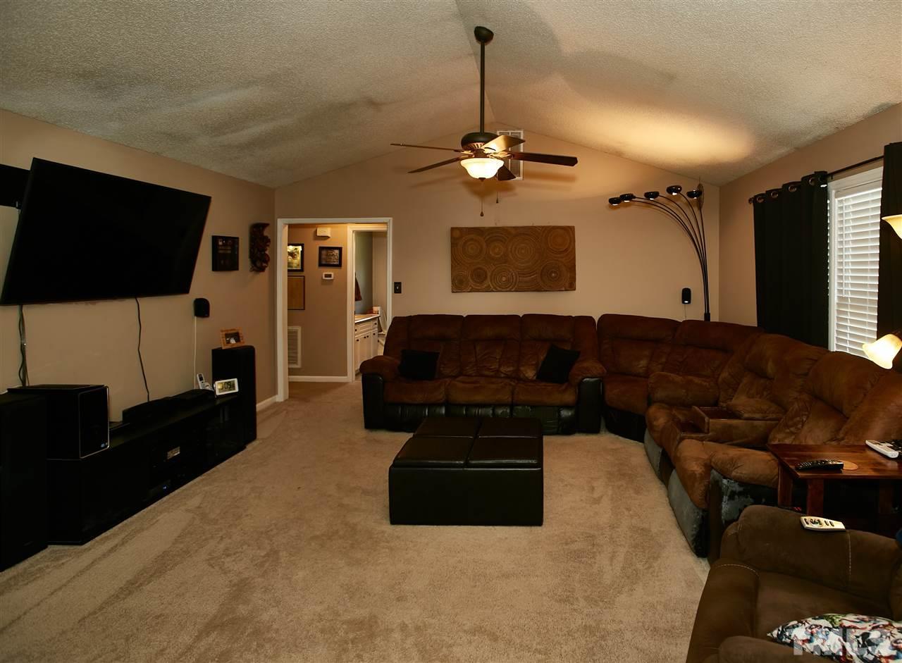 517 Jordan Ridge Lane Raleigh, NC 27603 - Photo 3 of 16 a living room with furniture a flat screen tv and kitchen view