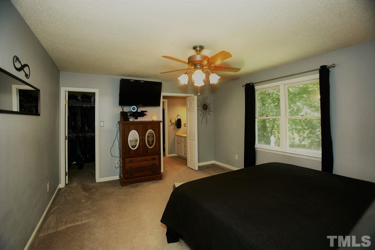 517 Jordan Ridge Lane Raleigh, NC 27603 - Photo 9 of 16 a bedroom with a bed and a tv
