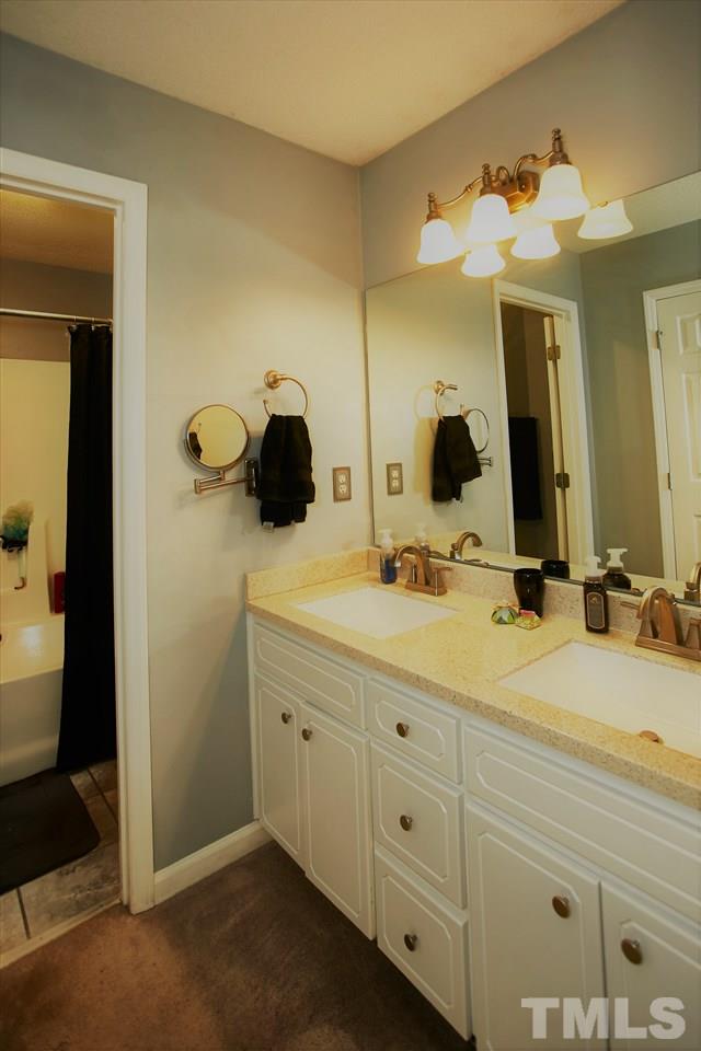 517 Jordan Ridge Lane Raleigh, NC 27603 - Photo 10 of 16 a bathroom with a double vanity sink and a mirror