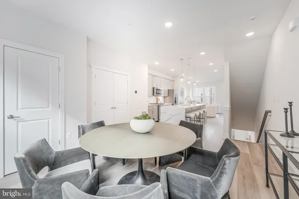 a dining room with furniture window and wooden floor