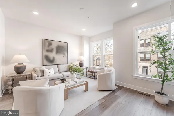 a living room with furniture and a large window