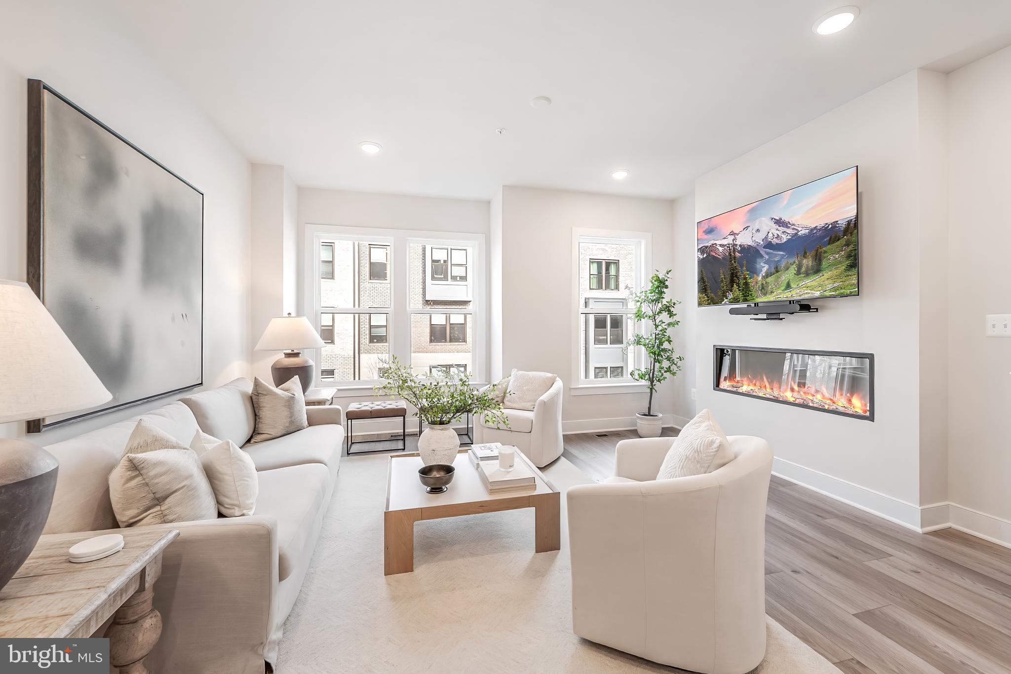 12742 Verdant Way Reston, VA 20191 - Photo 19 of 51 a living room with furniture a flat screen tv and a floor to ceiling window