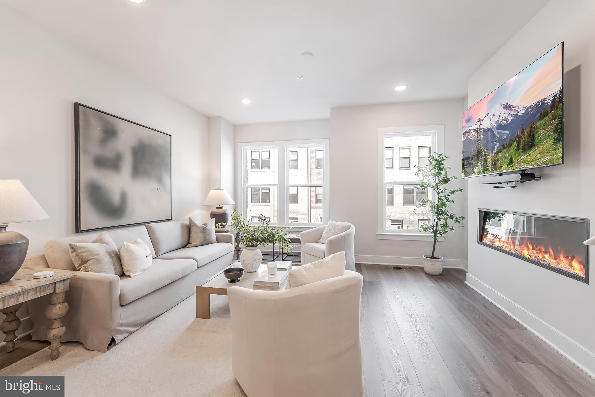 12742 Verdant Way Reston, VA 20191 - Photo 20 of 51 a living room with furniture a flat screen tv and a fireplace