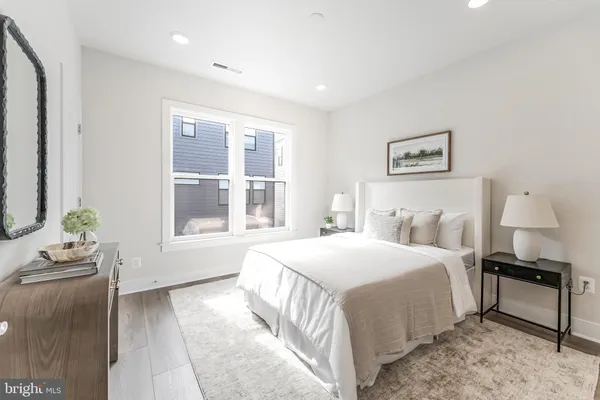 a bedroom with a bed and a painting on the wall