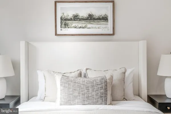 a bedroom with a bed and a mirror