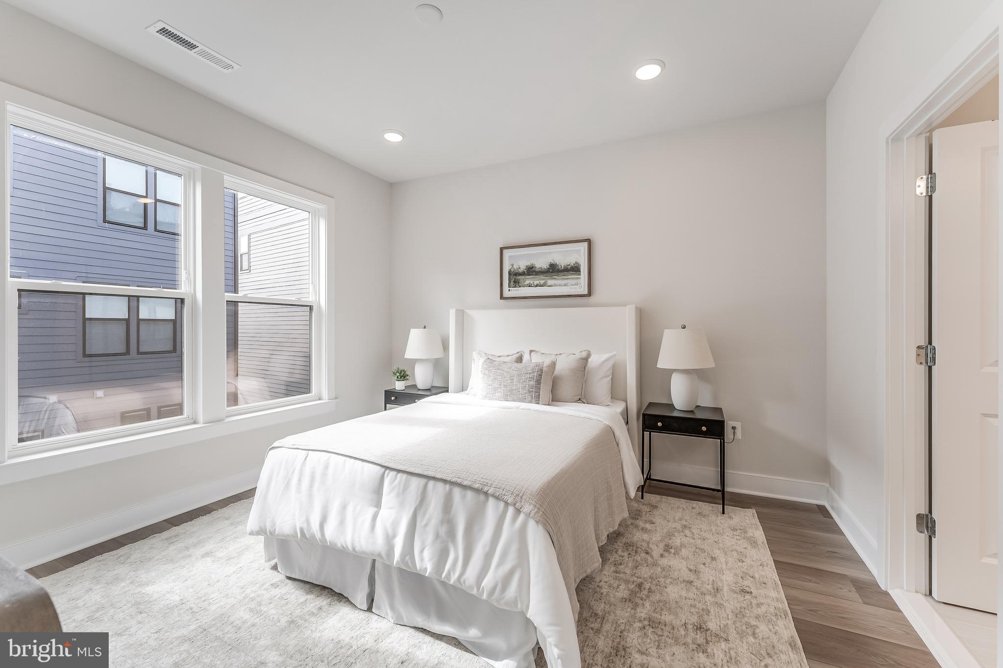 12742 Verdant Way Reston, VA 20191 - Photo 26 of 51 a bedroom with a bed and a large window